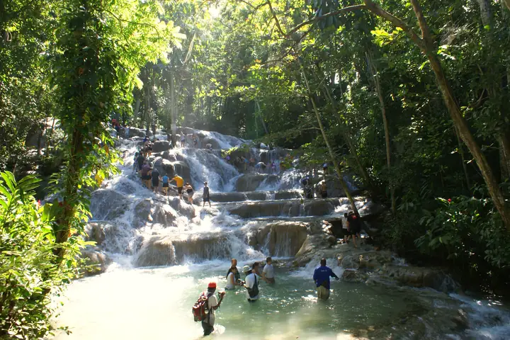 Visitors climbing Dunn's River Falls hand in hand, Ocho Rios