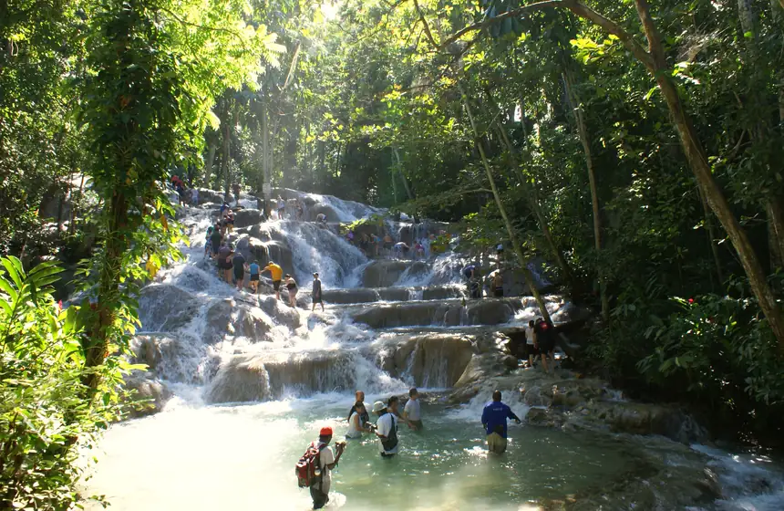 Visitors climbing Dunn's River Falls hand in hand, Ocho Rios