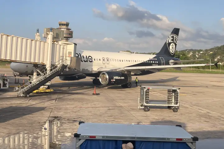 Plane at a jet bridge at Sangster International Airport (MBJ), Montego Bay
