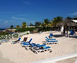 Sun loungers on a white-sand beach in Montego Bay