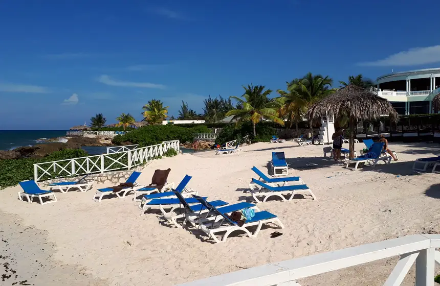 Sun loungers on a white-sand beach in Montego Bay