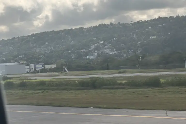Runway at Sangster International Airport (MBJ) with the Montego Bay hills