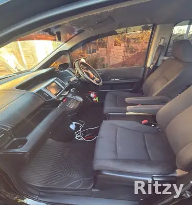 Inside the Ritzy Tours JA van, front seats