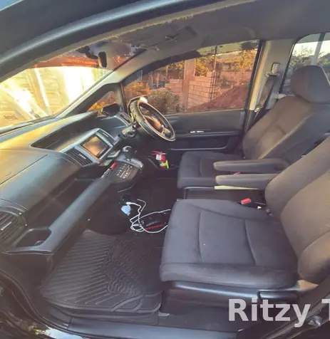 Inside the Ritzy Tours JA van, front seats